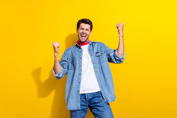 Photo portrait of attractive young man shout raise fists celebrate luck dressed stylish denim...