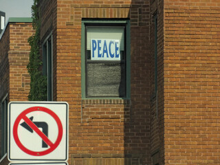 Posted on the side of buildings prohibiting a right turn with a peace symbol