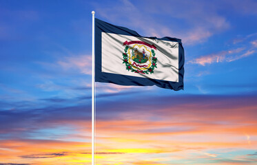  West Virginia  flag on flagpoles and blue sky.