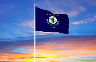 Kentucky flag on flagpoles and blue sky.