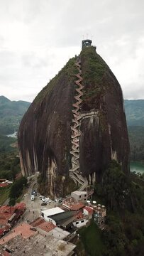 Aerial drone footage of El Penon de Guatape near Medellin in Antioquia, Colombia. Large and unique alone rock with stairs to the top, touristic place. Big stone in Colombia. High quality 4k footage.
