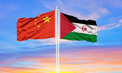 Western Sahara and China flag waving in the wind against white cloudy blue sky together. Diplomacy concept, international relations