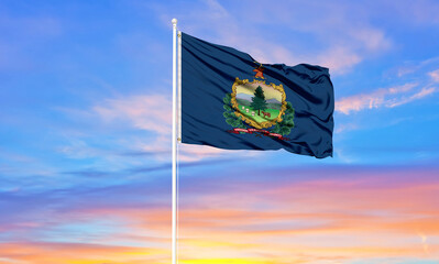 Vermont flag waving in the wind against white cloudy blue sky   Diplomacy concept, international relations