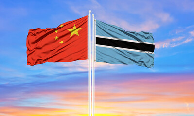Flag of China and Botswana waving in the wind against white cloudy blue sky together. Diplomacy concept, international relations