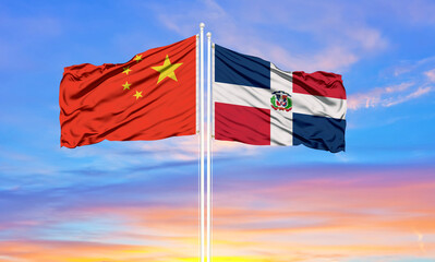 China and Dominican Republic two flags on flagpoles and blue cloudy sky . Diplomacy concept, international relations