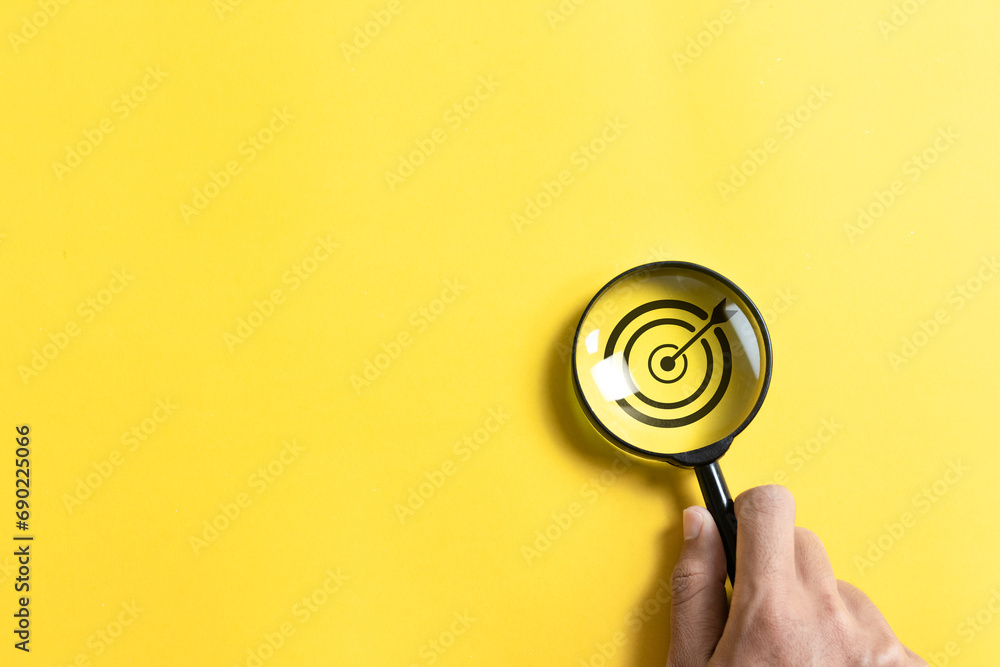 Poster magnifying glass focus to target icon on yellow background for business objective. set up business o