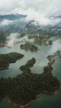 Aerial drone footage of El Penon de Guatape near Medellin in Antioquia, Colombia. Large and unique alone rock with stairs to the top, touristic place. Big stone in Colombia. High quality 4k footage.