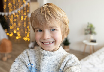 Portrait of a 7-year-old boy with blond hair, cheerful, smiling, good mood. against the background...
