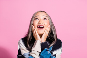 Photo of positive impressed girl hands touch cheeks open mouth look up empty space isolated on pink color background - obrazy, fototapety, plakaty