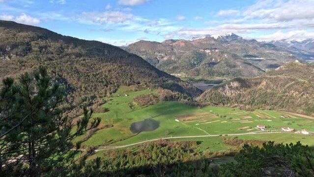 Video Panorama of a mountain village seen from above. Shot of the road that leads to the town, of trees and the peace that can be felt in the woods. Sunny day with no people around.