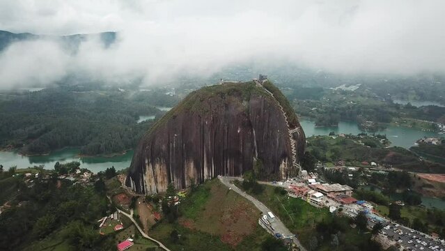 Aerial drone footage of El Penon de Guatape near Medellin in Antioquia, Colombia. Large and unique alone rock with stairs to the top, touristic place. Big stone in Colombia. High quality 4k footage.