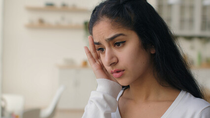 Tired sick woman arabian hispanic female girl touch head suffer from headache migraine feel pain...