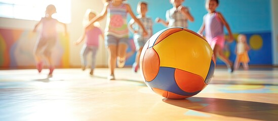 Group of kids has fun playing ball in physical education class in elementary school or day care center. Website header. Creative Banner. Copyspace image - obrazy, fototapety, plakaty