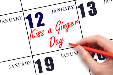 January 12. Hand writing text Kiss a Ginger Day on calendar date. Save the date.