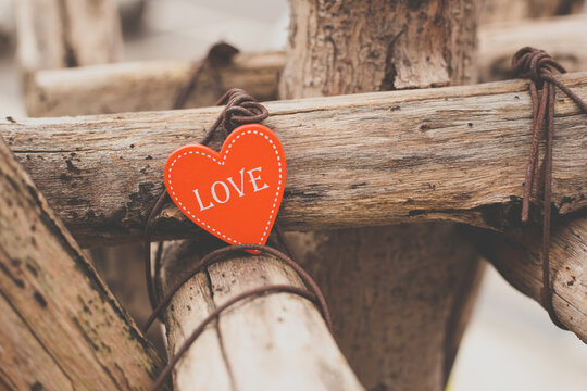 Wooden heart shape placed on trunk. Heart shape on wooden sticks. Toned image.