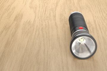 Black led flashlight on a wooden desk