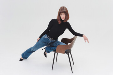 Fototapeta premium Women model in front of white background in studio. A girl with a short haircut, a professional model. Fashion, catwalk.