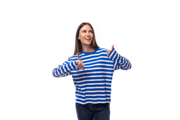 pretty young slender european model woman dressed in a blue sweater gesticulates actively. the...