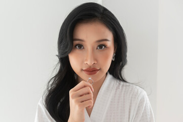 Bride in White bathrope with elegant diamond ring preparing for wedding day, Love and marriage concept