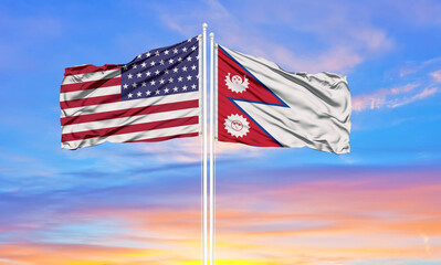 United States and Nepal two flags on flagpoles and blue cloudy sky . Diplomacy concept, international relations