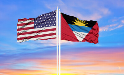 United States and Antigua and Barbuda two flags on flagpoles and blue cloudy sky . Diplomacy concept, international relations