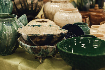 Colorful handmade pottery bowls at a market stall. Minimalist lifestyle. Shopping at local businesses