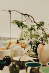 Colorful handmade pottery bowls at a market stall. Minimalist lifestyle. Shopping at local businesses