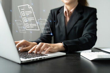 Businesswoman working on a laptop computer to document management online documentation database...