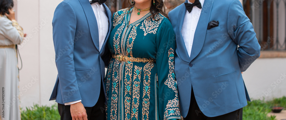 Wall mural moroccan wedding. women wear caftans and men wear tuxedos