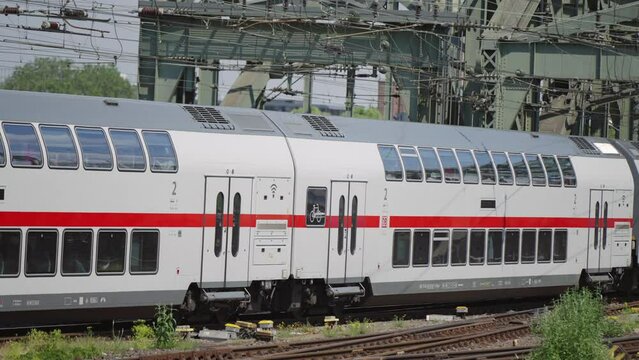 Train arrivial into Hauptbahnhof HBF station platform at Cologne from Hohenzollern bridge, slow motion