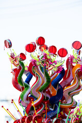 Fototapeta premium Colorful Chinese dragon toys in Chinese New Year festival.Chinese New Year Decoration, Dragon toy paper on festive background.