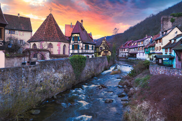 French traditional half-timbered houses and La Weiss river in Kayserberg village in Alsace, France - obrazy, fototapety, plakaty