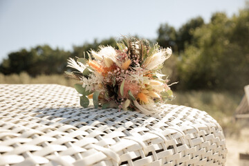 moderner Trockenblumenstrauß für die Braut auf einem Strandkorb am Meer - 690255252