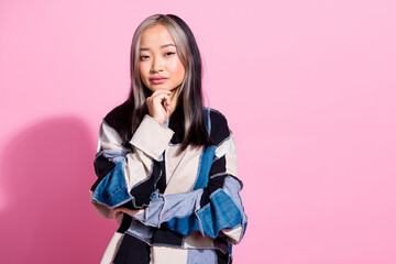 Photo of pretty creative minded girl hand touch chin contemplate empty space isolated on pink color...