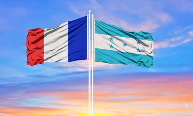 france and Honduras two flags on flagpoles and blue cloudy sky . Diplomacy concept, international relations