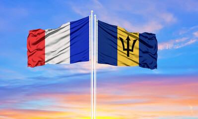 france and Barbados two flags on flagpoles and blue cloudy sky . Diplomacy concept, international relations