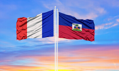 france and Haiti two flags on flagpoles and blue cloudy sky . Diplomacy concept, international relations