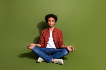Full length photo of nice young man sit floor meditation lotus pose dressed stylish brown garment...