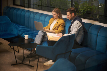People working with documents in a coworking space