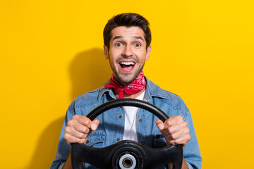 Photo portrait of nice young man hold steering wheel excited dressed stylish denim garment isolated...