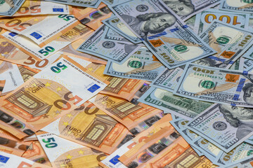 50 euro and 100 dollar bills scattered on the table as a background 8