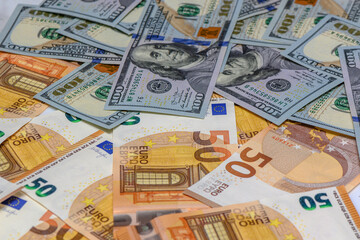50 euro and 100 dollar bills scattered on the table as a background 3
