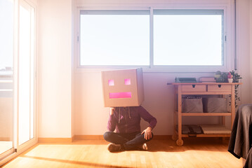 Man with box on head sitting on the floor