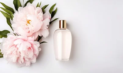 Deurstickers Pioenrozen Women's elegant perfume bottle with fresh pink peonies, top view
