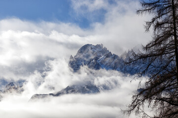 Snow covered peaks of the Sesto Dolomites with clouds in winter, mountains of the Alps, South Tyrol, Italy, Europe - obrazy, fototapety, plakaty