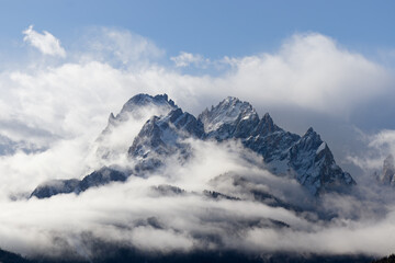 Snow covered peaks of the Sesto Dolomites with clouds in winter, mountains of the Alps, South...