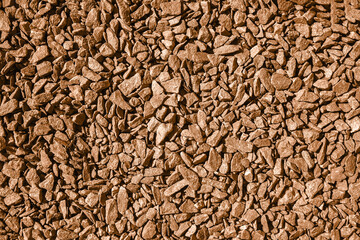 Texture of natural crumbs is made of marble stone toned in Peach Fuzz color of the year 2024.