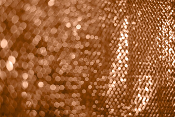 Holiday backdrop with glitter colored in Peach Fuzz color 2024.