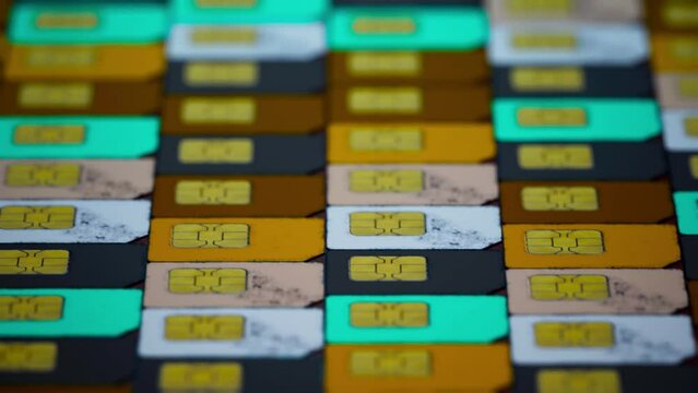 many sim cards stacked on the ground led each other in rows of different colors. Telecommunication technology background banner. 3d render animation with blurr