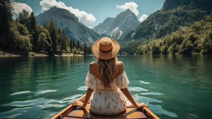  Women wear casual boho hats and clothes. Sit in a boat on the lake with a spectacular mountain and river view. travel concept © Thanaphon